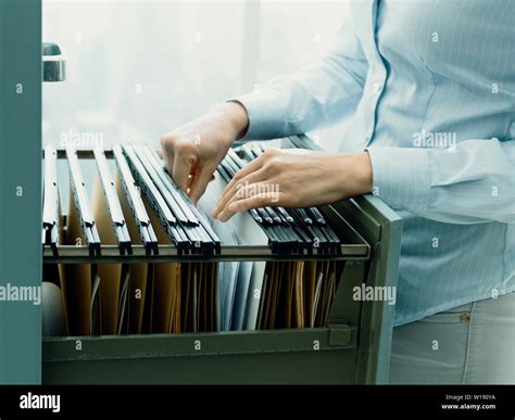 Office Clerk Searching Files In The Filing Cabinet Stock Image Image