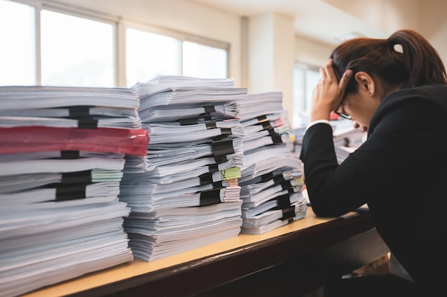 Office Woman Worker Is Distressed With A Lot Of Paperwork On Her Desk