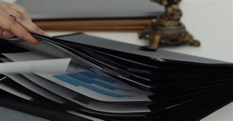 Organized Person Putting Her Paperworks In A Folder Orderly Free Stock Video