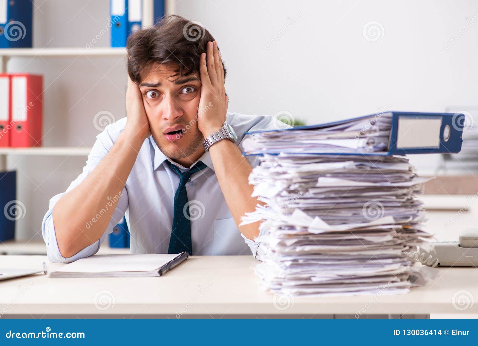 Overloaded Busy Employee With Too Much Work And Paperwork Stock Photo