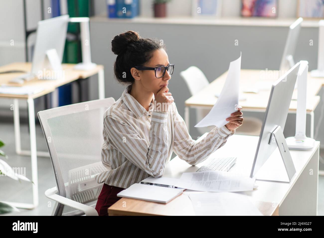 Paperwork Concept Focused Female Office Worker Reading Paper Or