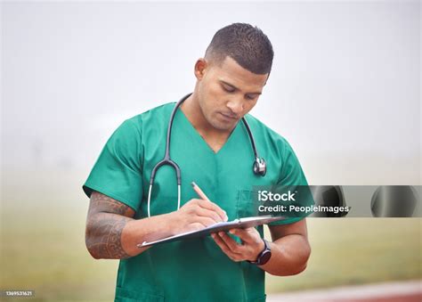 Paperwork Is Important Cropped Shot Of A Handsome Young Male Paramedic Filling Out Paperwork