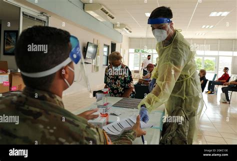 Pfc Michael Col N A Combat Medic Hands A Resident S Paperwork To Pfc