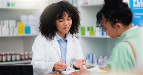 Pharmacist Helping A Customer In A Pharmacy Woman Signing Medical