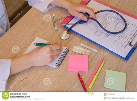 Physician Working With Paper In Hospital Office Room Therapeutist