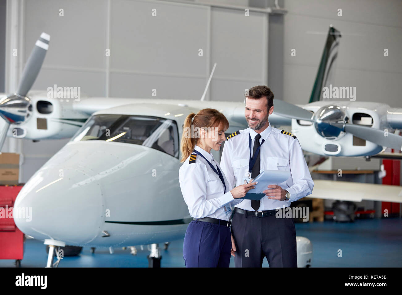 Pilots Discussing Paperwork Near Airplane Stock Image F020 2341 Science Photo Library