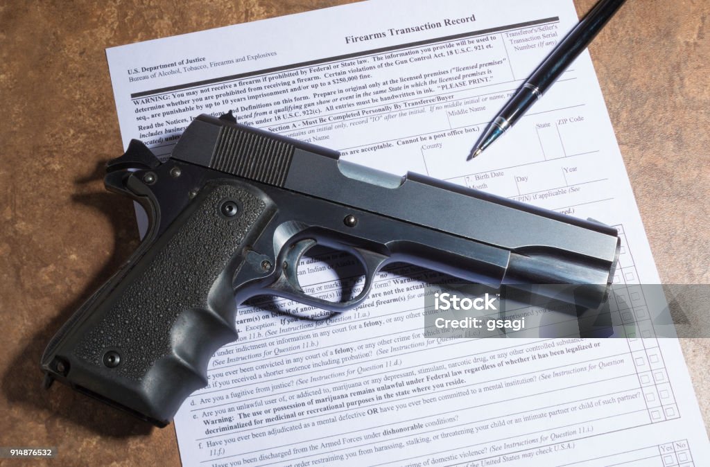 Pistol With The Paperwork To Transfer The Gun Stock Photo Download