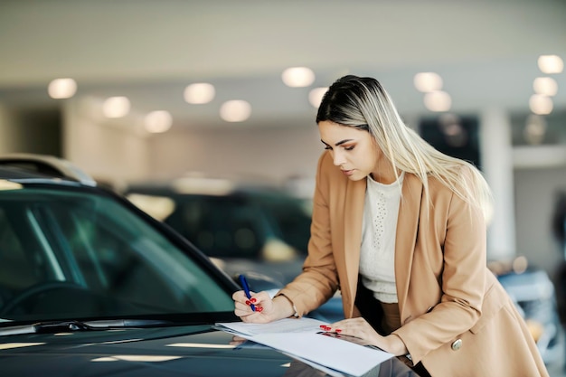 Premium Photo A Buyer Is Signing Contract While Standing At The Car