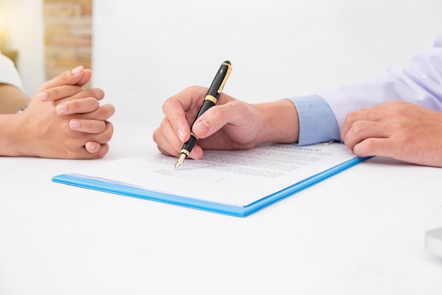 Premium Photo Cropped Image Of Doctor Explaining Paperwork To Patient