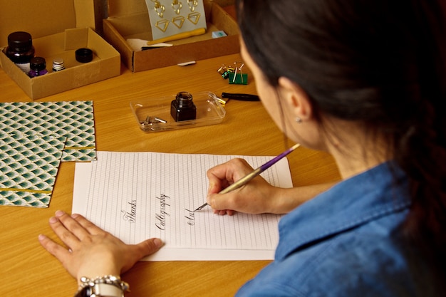 Premium Photo Indian Girl Writes With Ink Pen On A White Paper Sheet