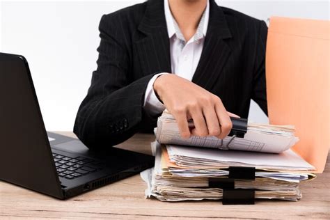 Premium Photo Office Worker Handles Documents On The Desk