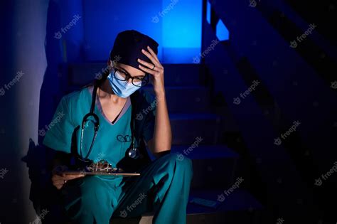 Premium Photo Pensive Female Doctor Sitting On Stairs