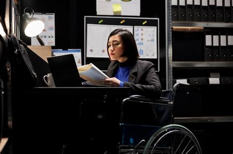 Premium Photo Wheelchair User Checking Annual Profit Revenue Paperwork Before Business Meeting