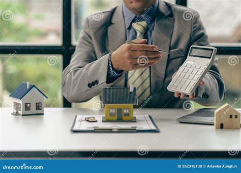 Real Estate Agent Or Bank Officer Working With Paperwork And Laptop