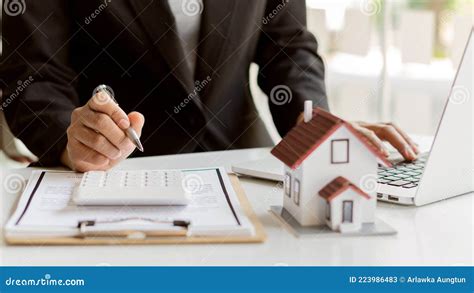 Real Estate Agents Are Working On Paperwork And House Plans On Their