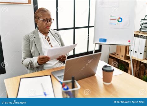 Senior African American Woman Business Worker Reading Paperwork Working