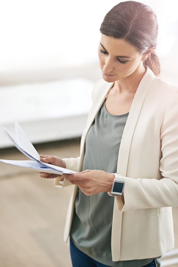 Staying On Top Of The Paperwork A Young Businesswoman Standing In Her