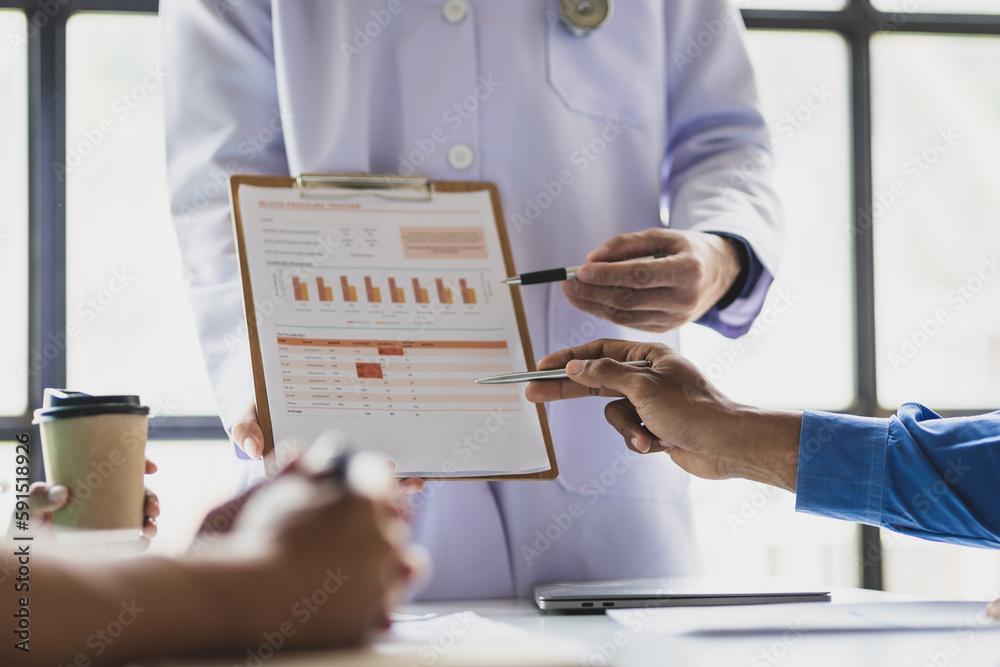 Team Medical Analysts And Doctors Consulting With Paperwork Of Graphs