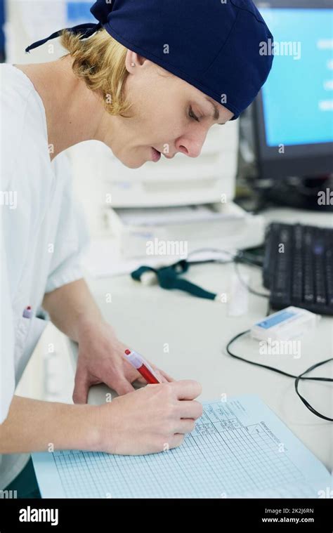 The Administrative Side Of Doctoring Shot Of A Young Surgeon Filling