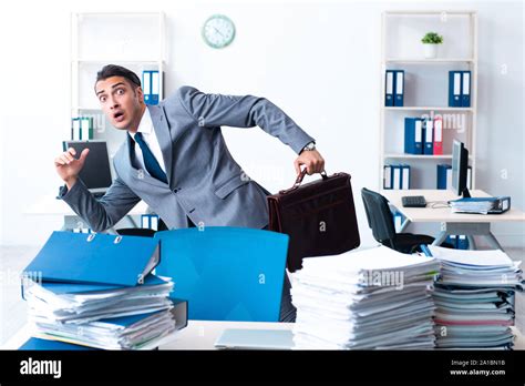 The Businessman With Heavy Paperwork Workload Stock Photo Alamy