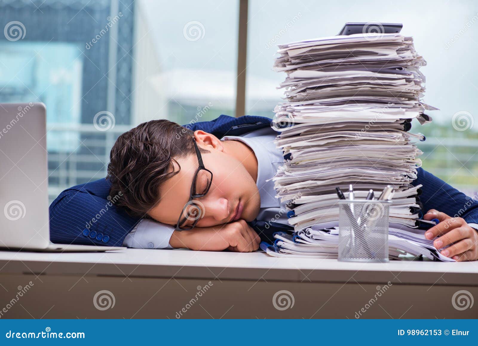 The Businessman With Pile Stack Of Paper Paperwork In The Office Stock