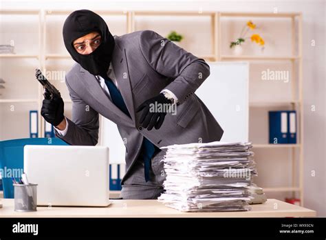 The Male Gangster Stealing Information From The Office Stock Image