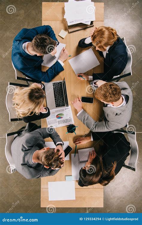 Top View Of Businesspeople Doing Paperwork At Table Stock Photo Image Of Notebook Documents