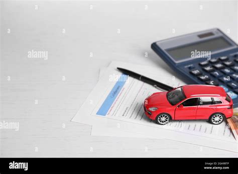 Toy Car Money Documents And A Calculator On The Table The Concept Of