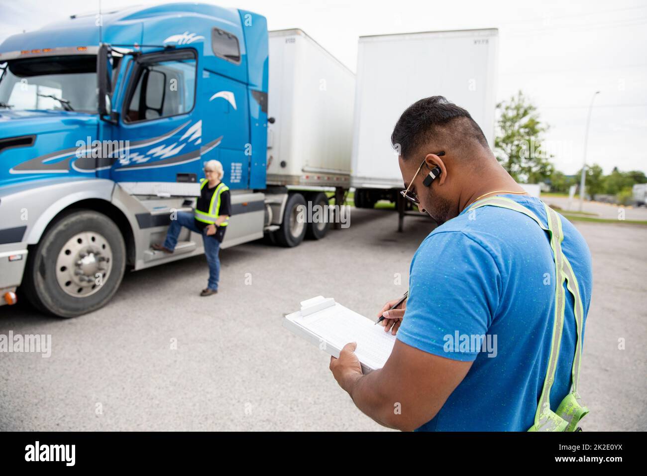 Trucker Looking At Paperwork For Container Semi Truck Stock Photo Alamy