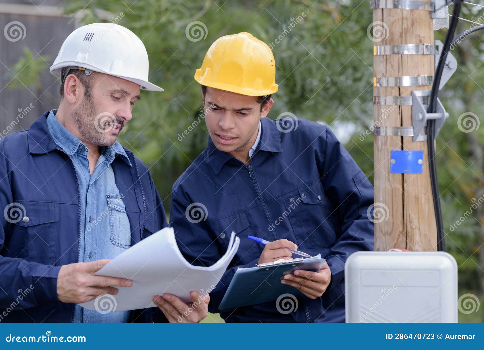 Two Male Engineers With Paperwork By Electric Pole Stock Image Image Of Builder Line 286470723