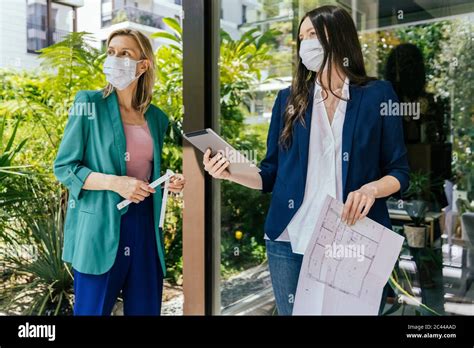 Two Real Estate Agents Wearing Face Masks While Inspection Outdoor Area Of House Stock Photo Alamy