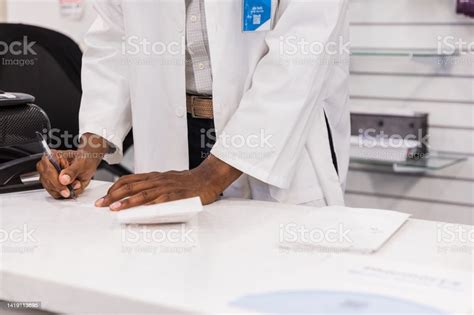 Unrecognizable Pharmacy Staff Completing Paperwork Stock Photo Download Image Now 35 39