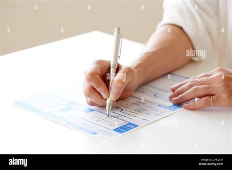 Woman S Hand Filling Out Paperwork Stock Photo Alamy