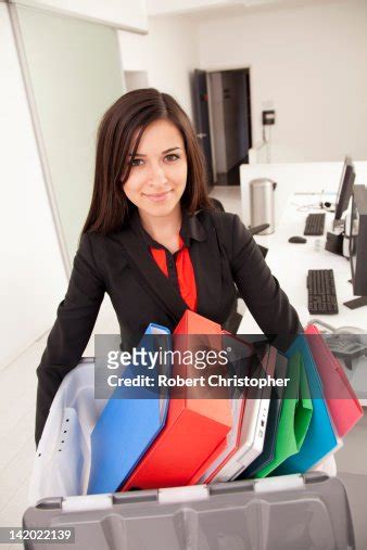 Young Businesswoman Looking At Paperwork In Binder High Res Stock Photo Getty Images