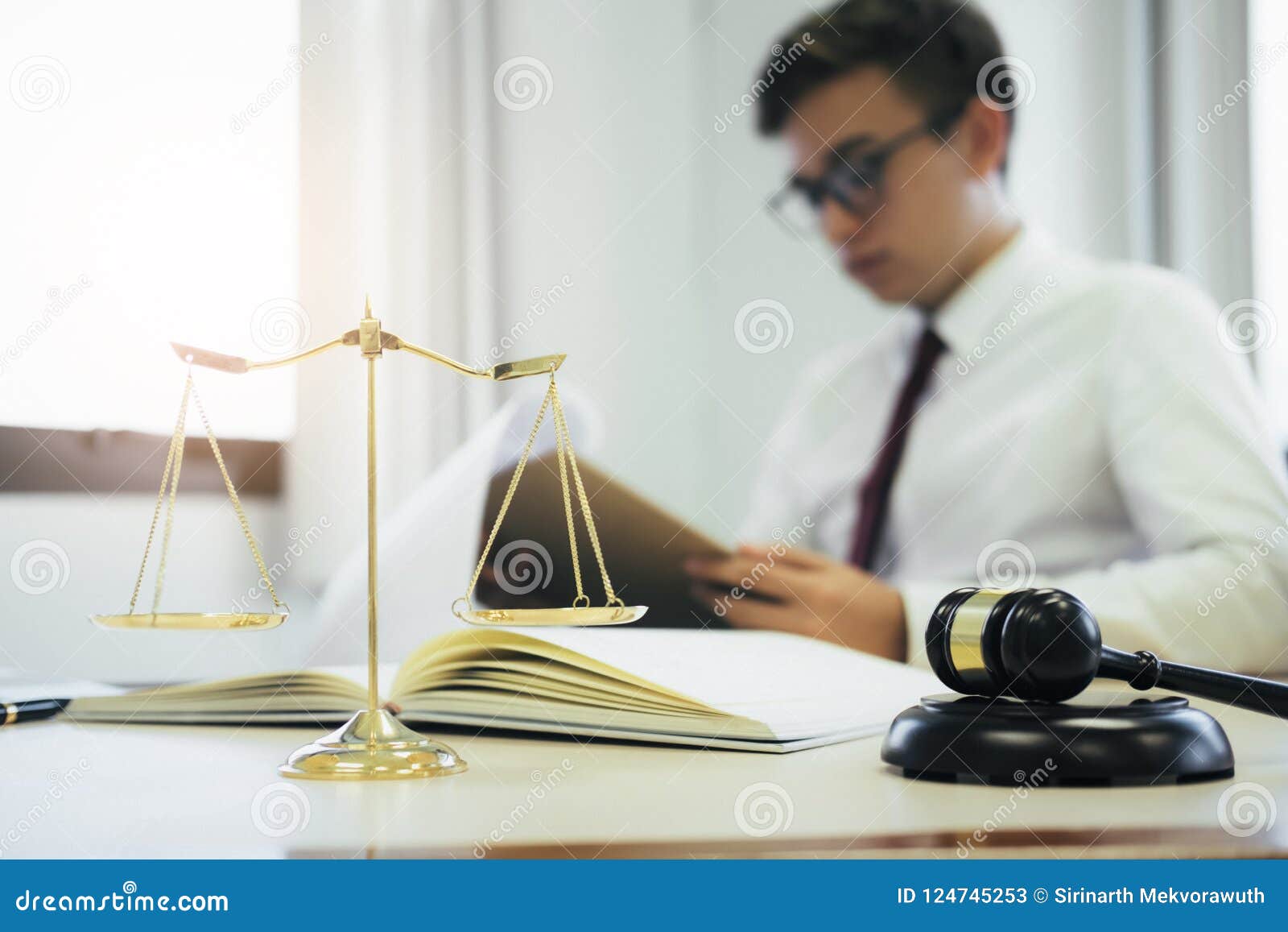 Young Lawyer Signing Paperwork At His Desk In An Office Stock Photo