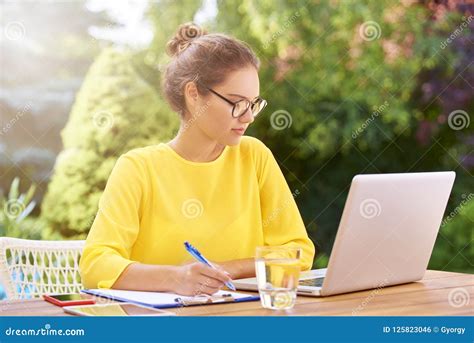 Young Woman Doing Some Paperwork And Using Laptop Stock Image Image